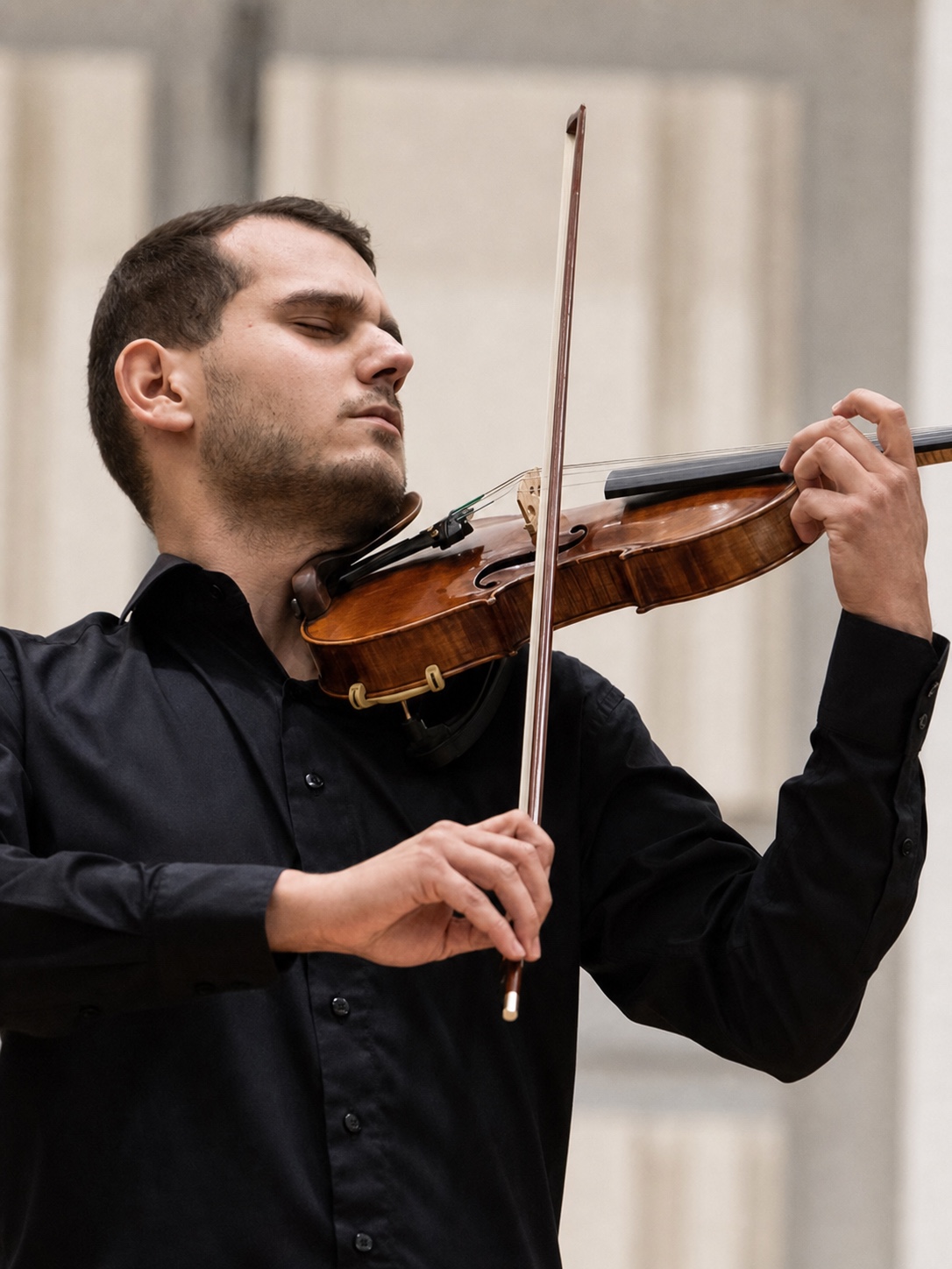 Marek Juran performing a violin solo with orchestra