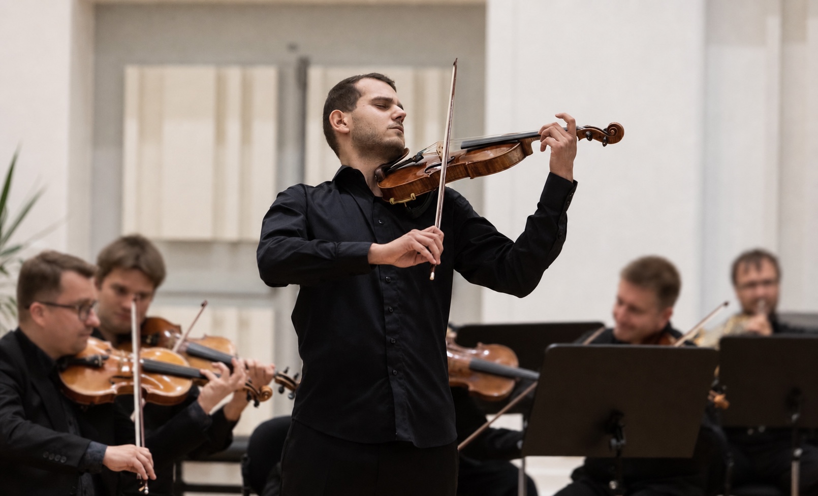 Marek Juran performing a violin solo with orchestra