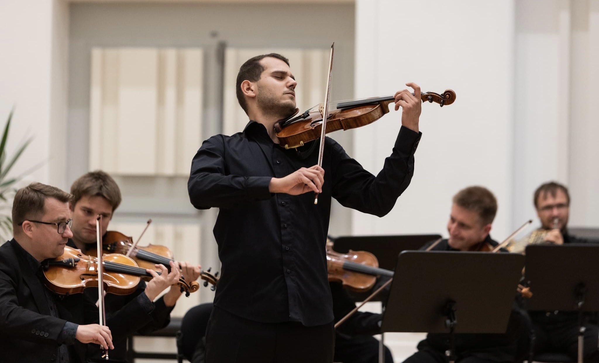 Marek Juran performing a violin solo with orchestra