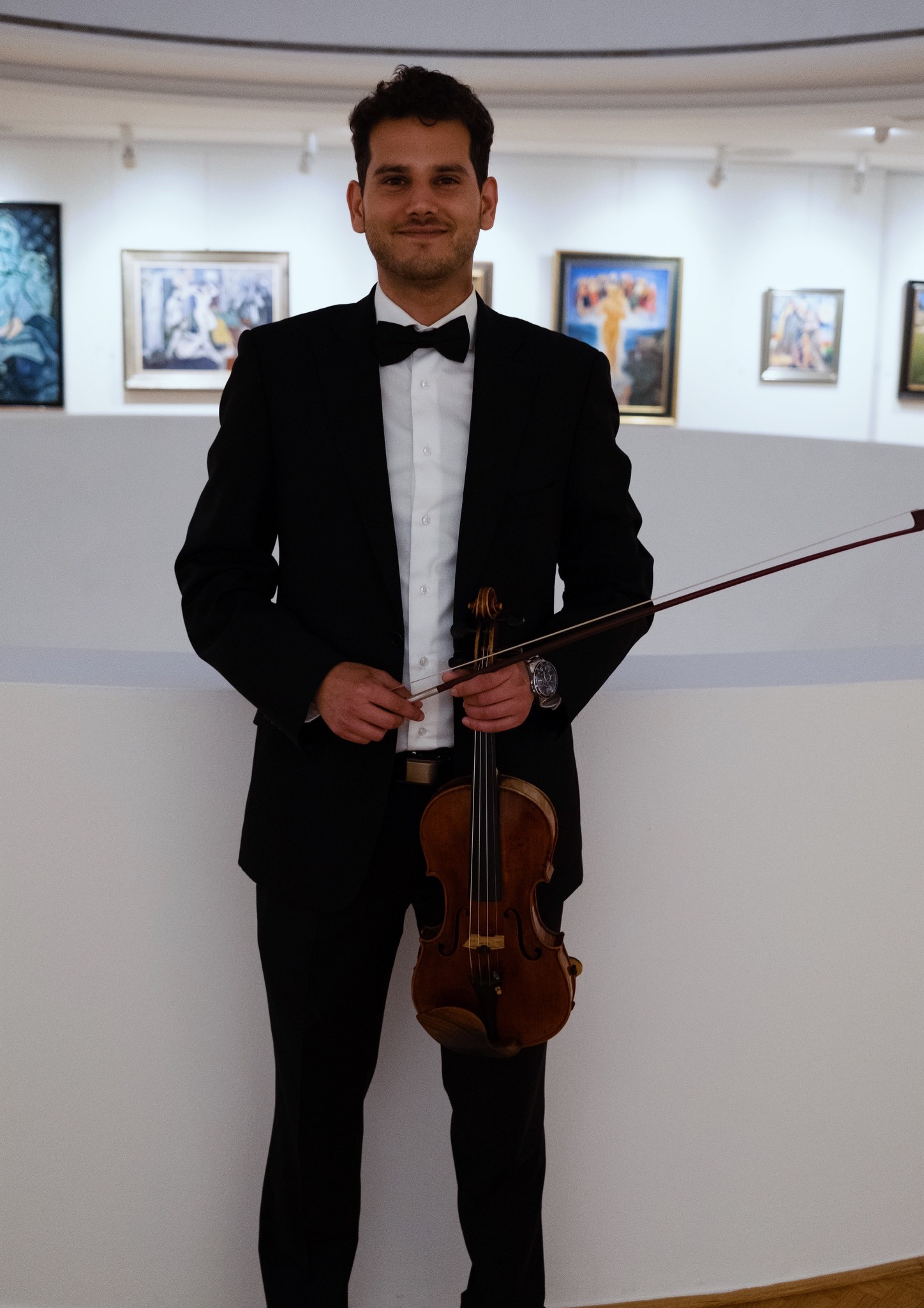 Marek Juran in concert attire, holding his violin